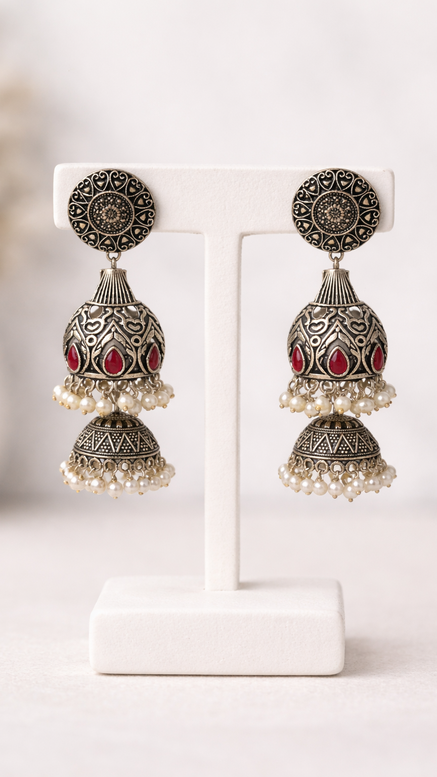 Silver toned metalic engraved Red stones white pearl border earrings