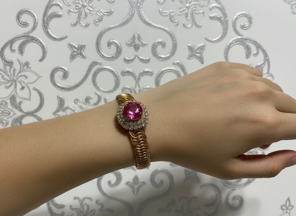 Cluster pink central stone with white studded stones Golden metal strap Bracelet