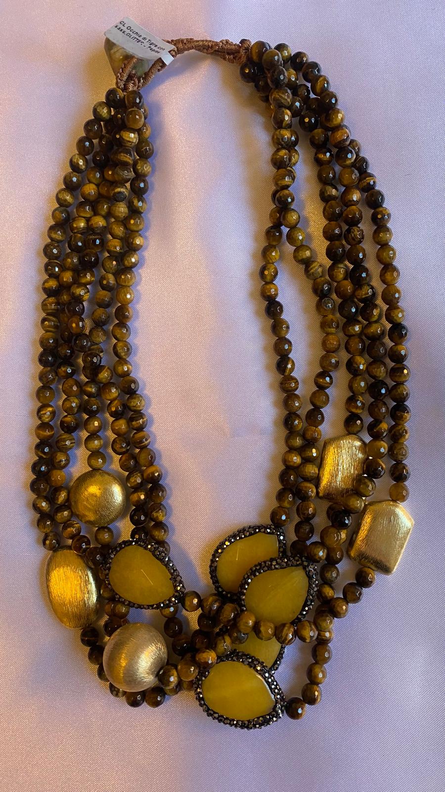Multi-strand Necklace made of Tiger's eye, Golden nuggets, and Glitter with a Mother of Pearl clasp.