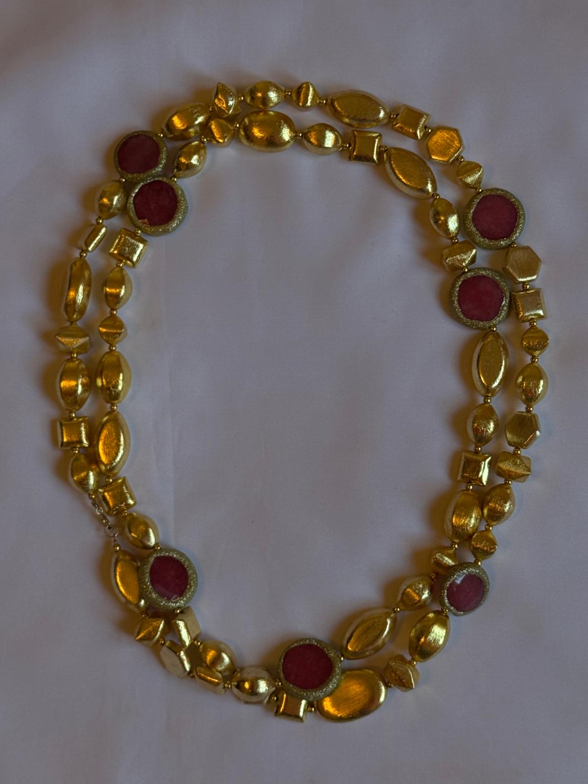 Gold necklace with red stones